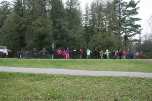 Students from a grade 4 class at Roger Neilson Public School form a line to demonstrate the width and location of a proposed bridge across Jackson Park. 