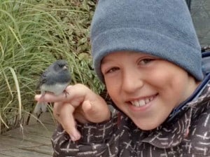 Rowan Maury holding  junco after window collision